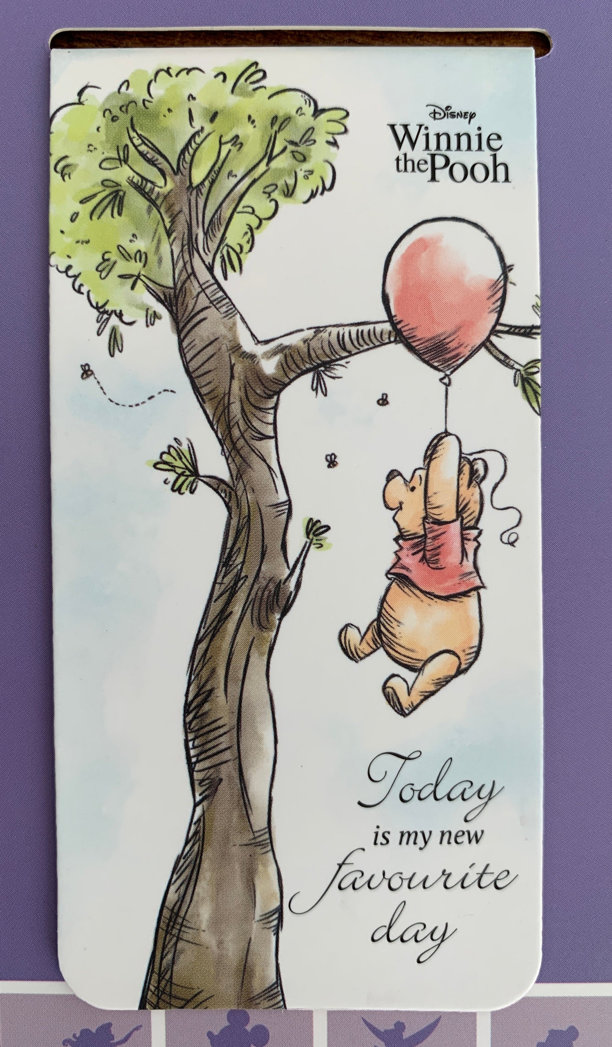 Winnie the Pooh bookmark with a tree and heart design on a white background