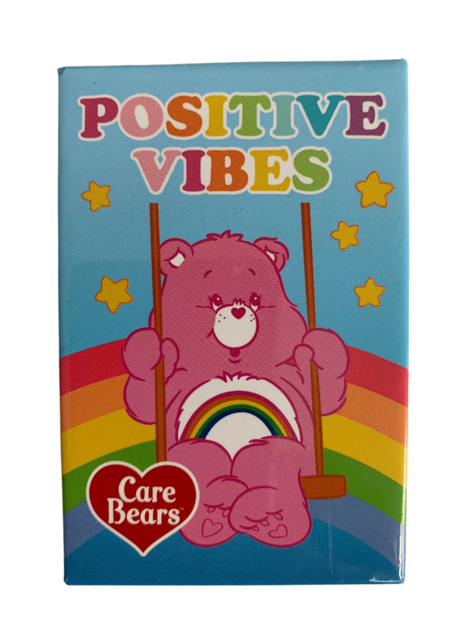 Fridge magnet with a pink Care Bear holding a rainbow, stars, and 'Positive Vibes' text on a white background.