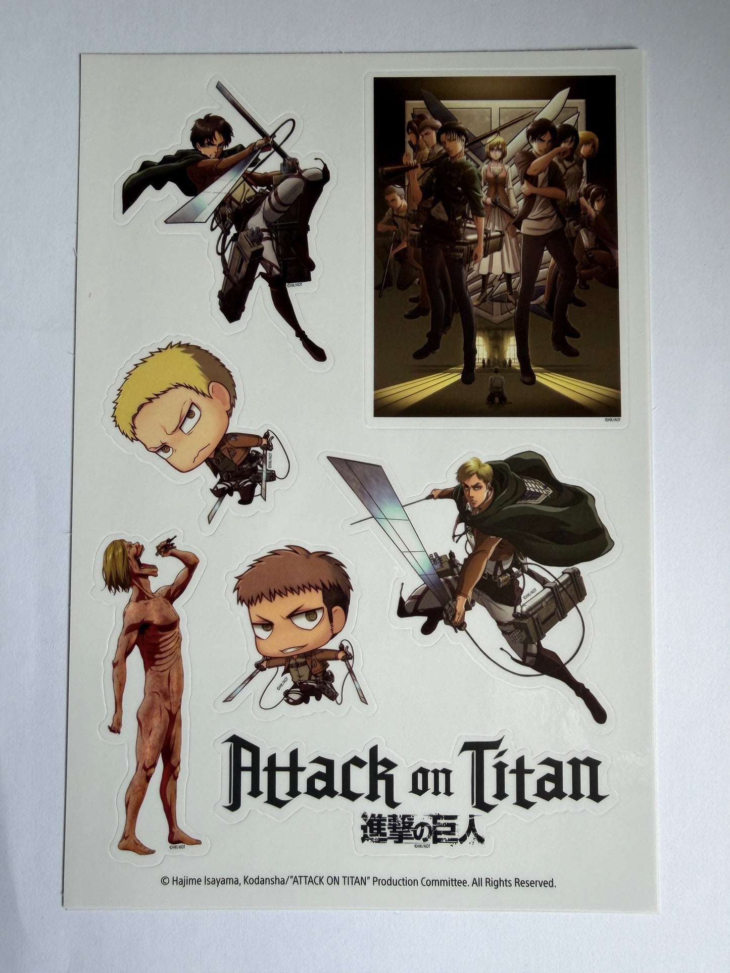 Sticker sheet from 'Attack on Titan' with various characters and scenes.