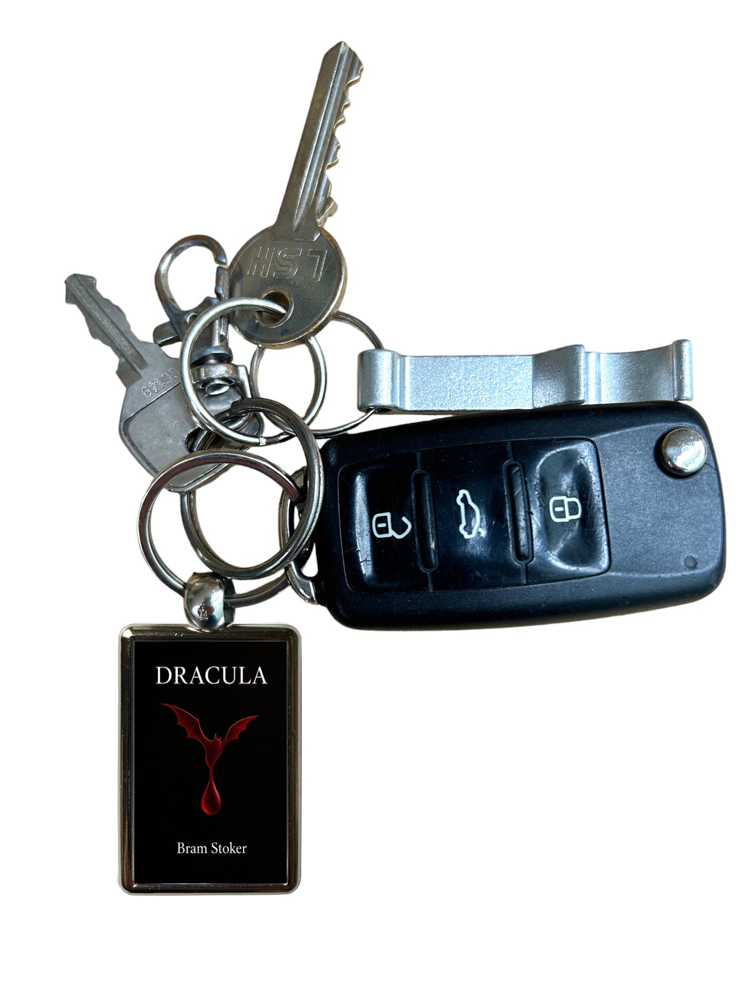A novelty keychain set featuring a black car key fob, two metal keys on a split ring, and a rectangular black tag with the word 'DRACULA' and a red bird emblem.