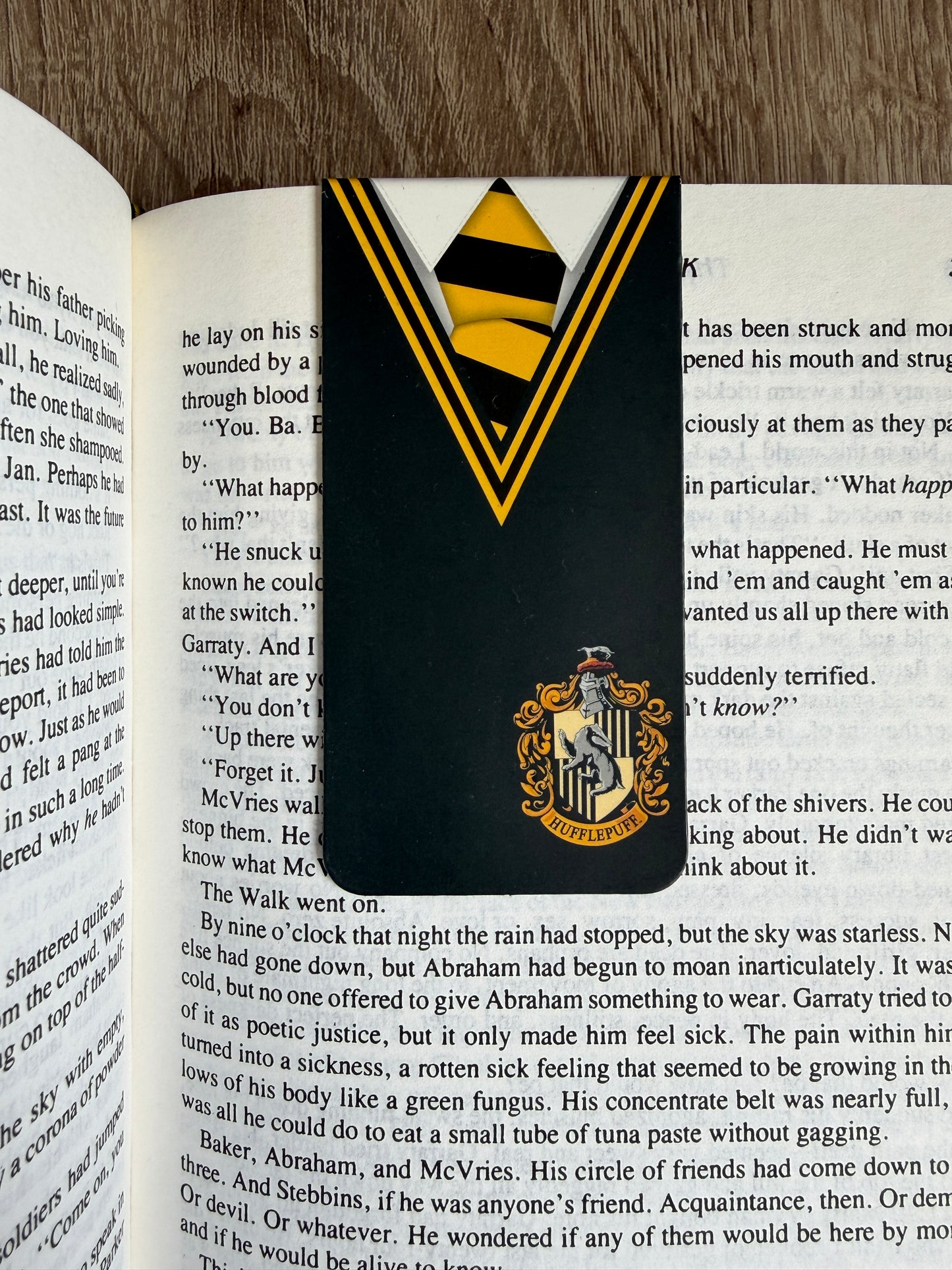 Bookmark with a crest design on an open book