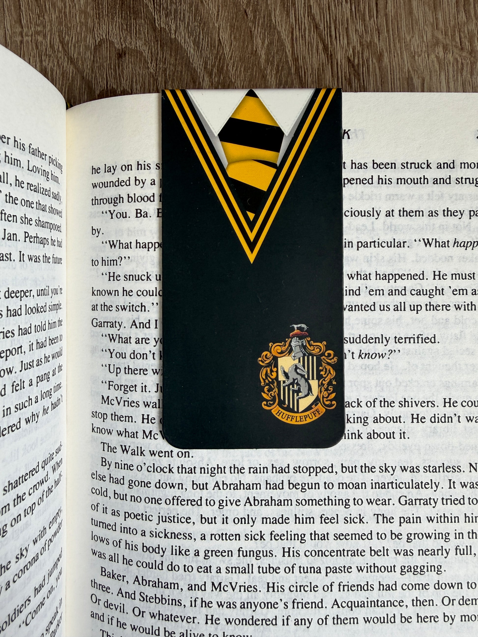Bookmark with a crest design on an open book