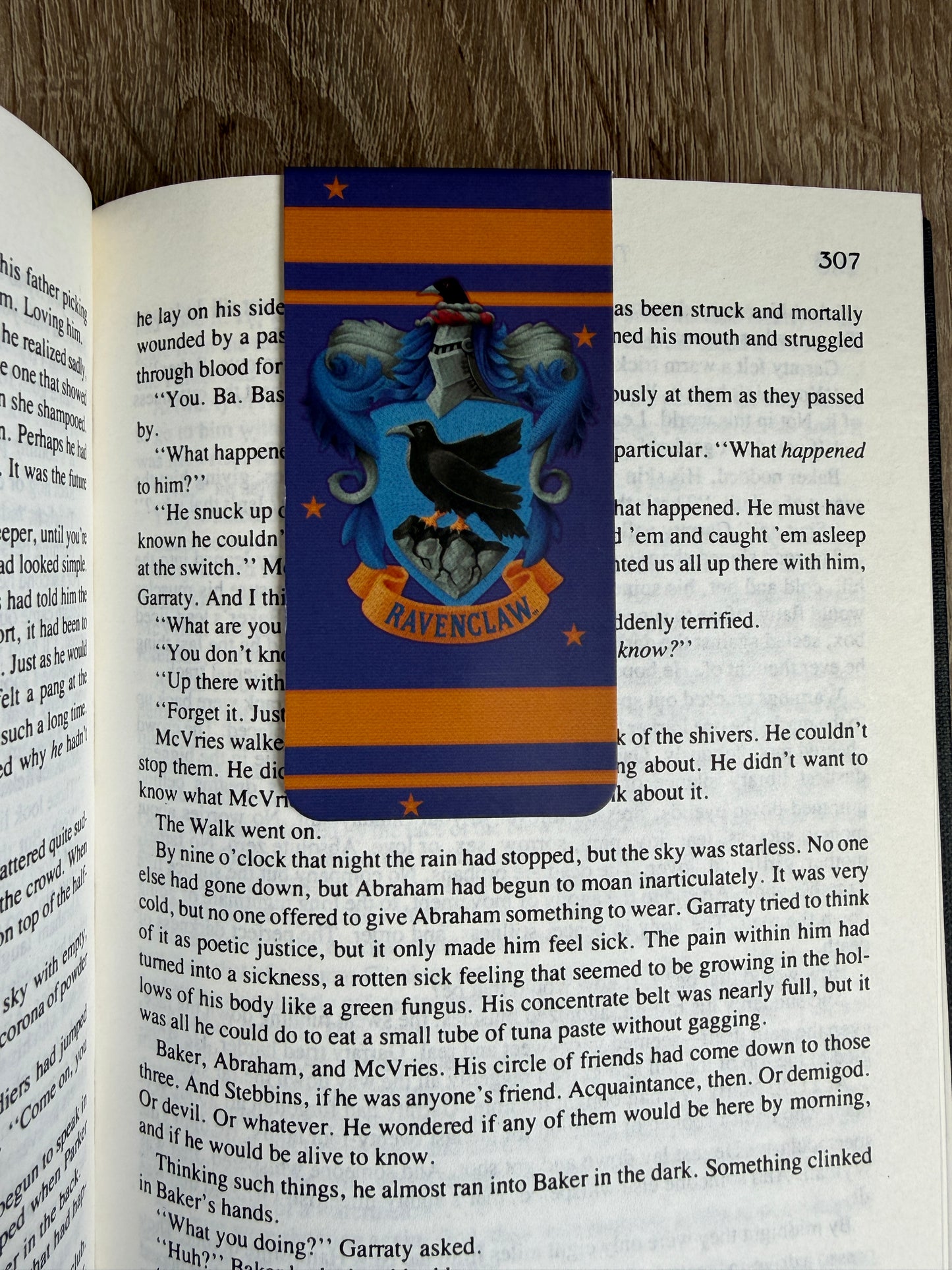 Book with a Hogwarts crest bookmark on an open book