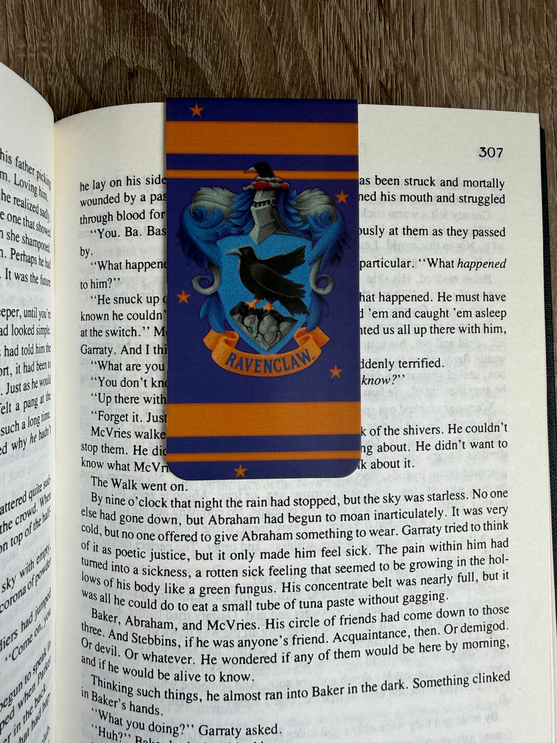Book with a Hogwarts crest bookmark on an open book