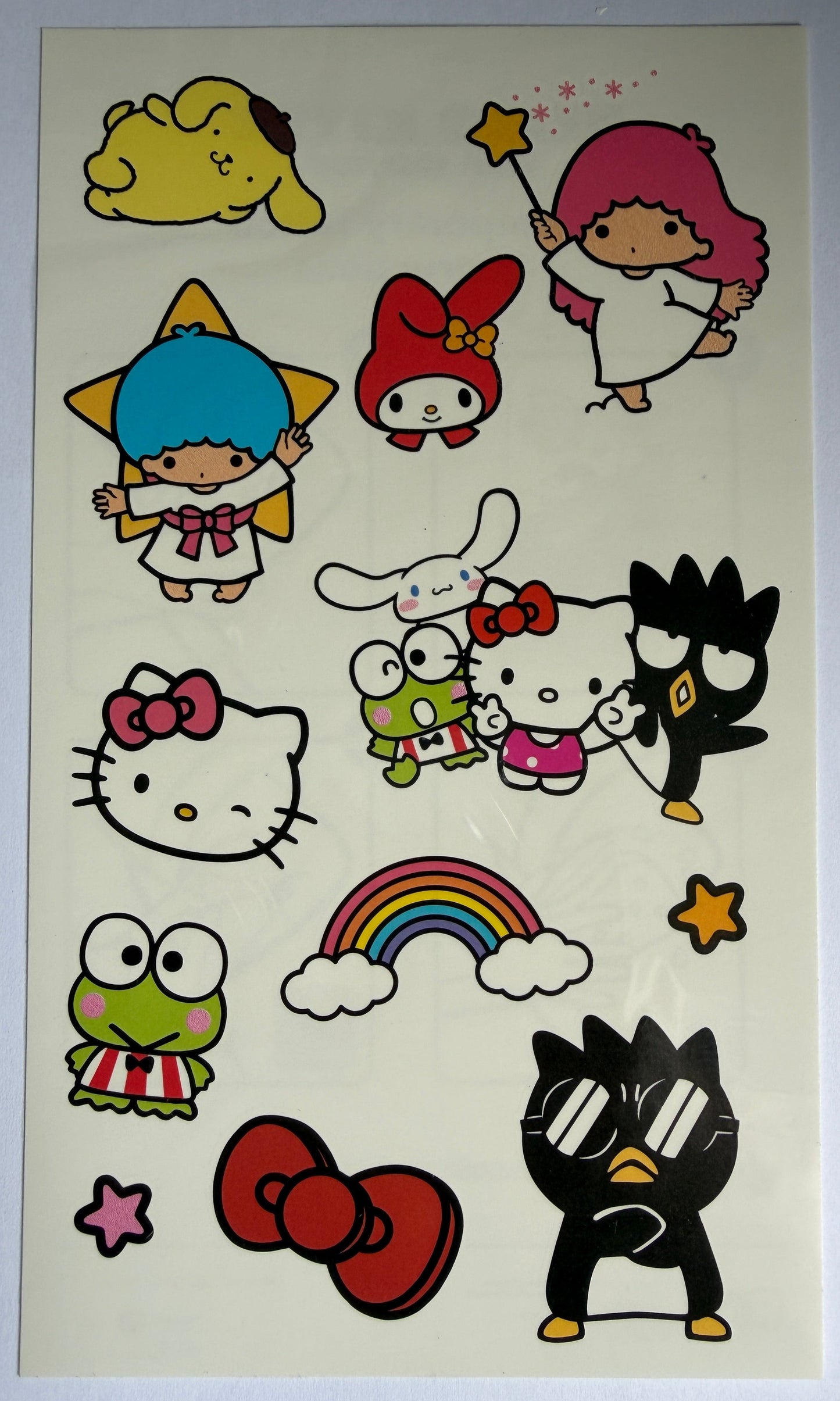 Sheet of colorful cartoon stickers featuring various characters on a light background
