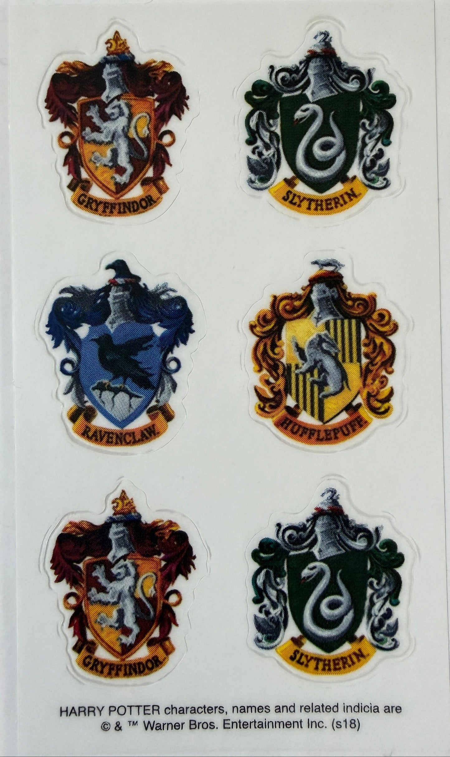Close-up of Harry Potter crest stickers on backing card