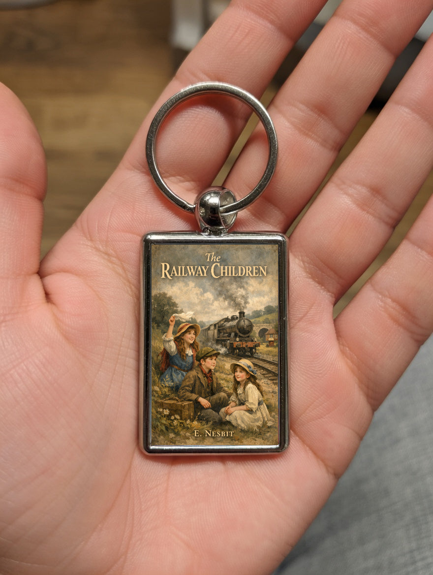 The Railway Children metal keyring shown in a hand