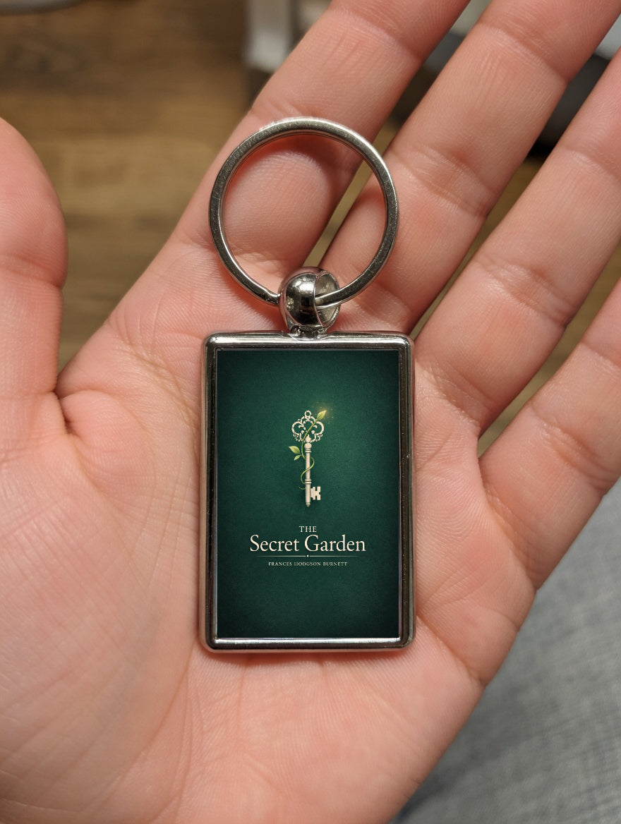 The Secret Garden metal keyring shown in a hand