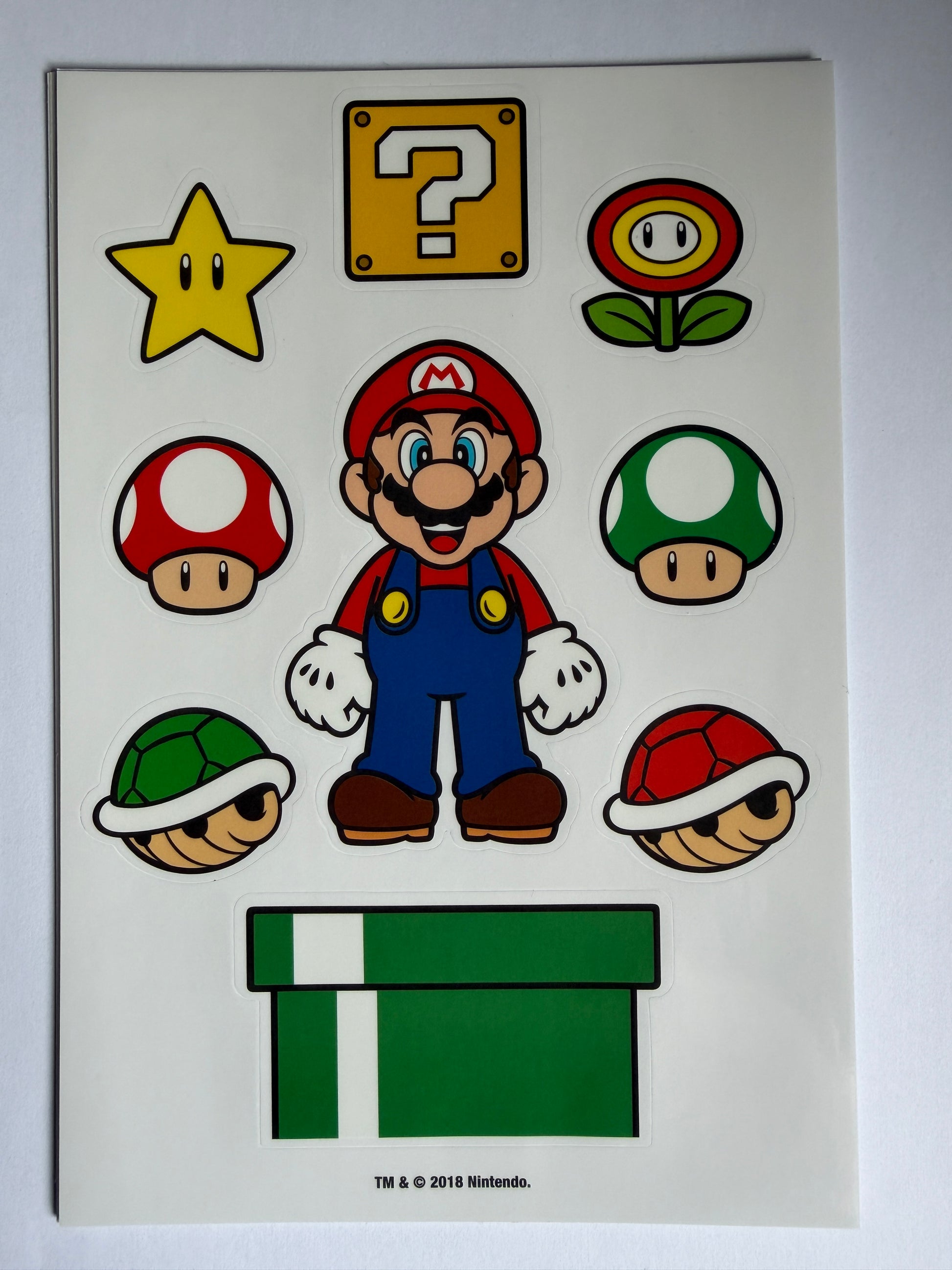 Sheet of Super Mario-themed stickers on a white background