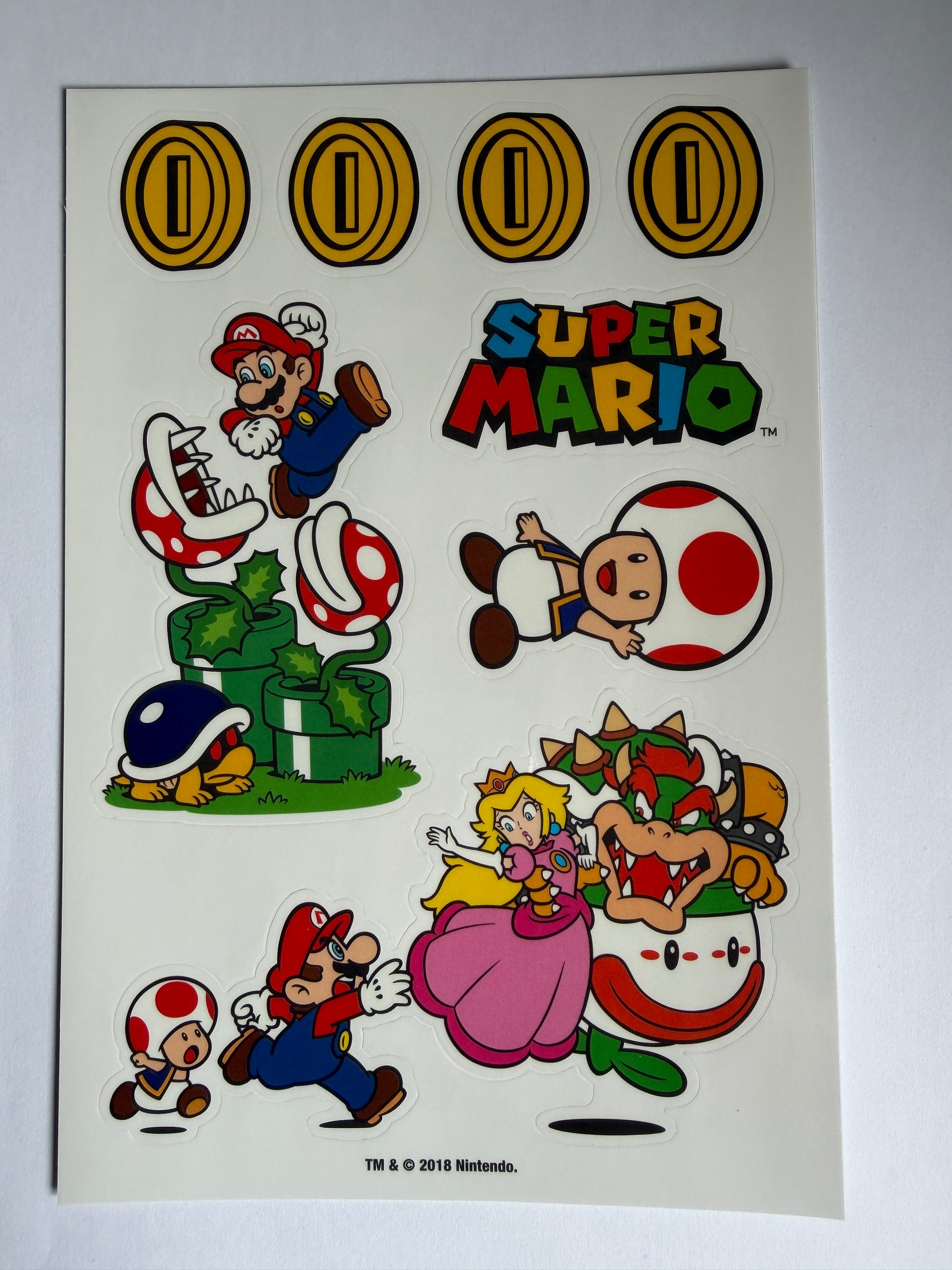 Sheet of Super Mario-themed stickers with characters and graphics on a white background.