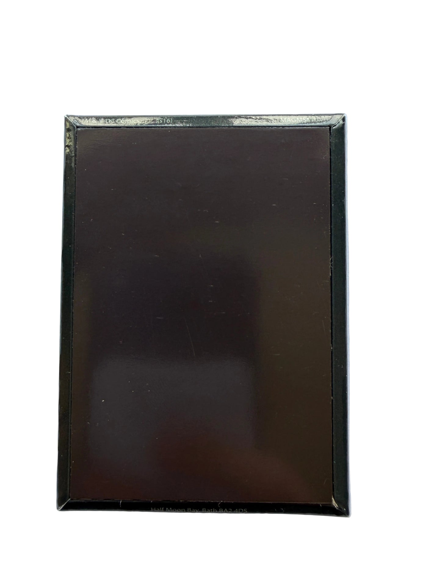 Black rectangular object with a reflective surface on a white background