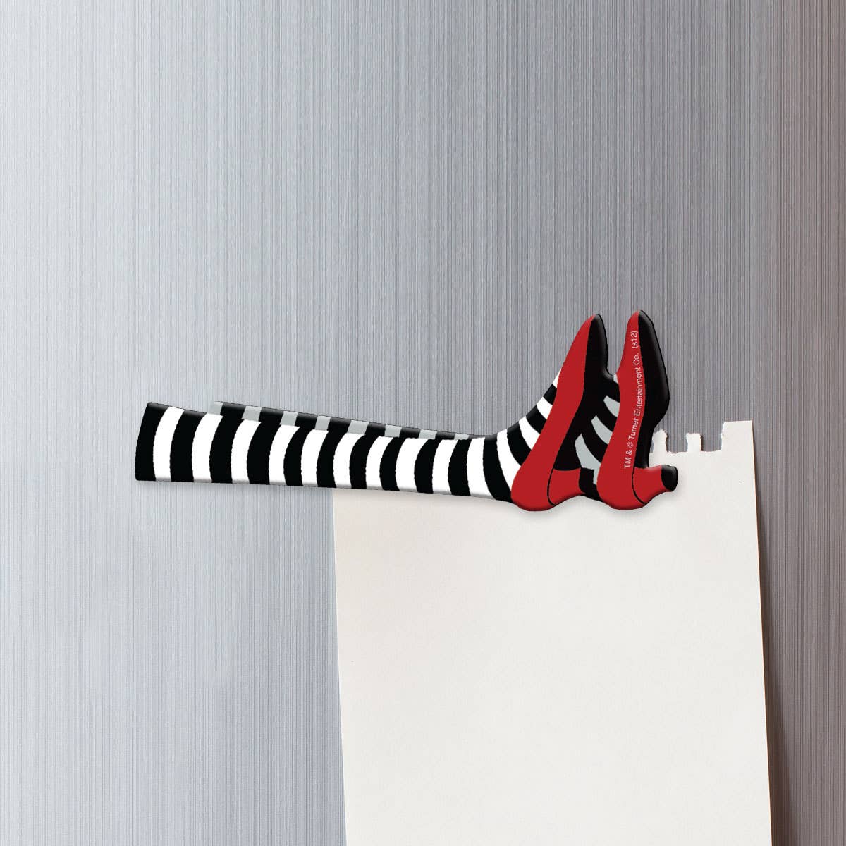 Black and white striped shoe with red accents on a fridge, The Wizard of Oz, holding note.