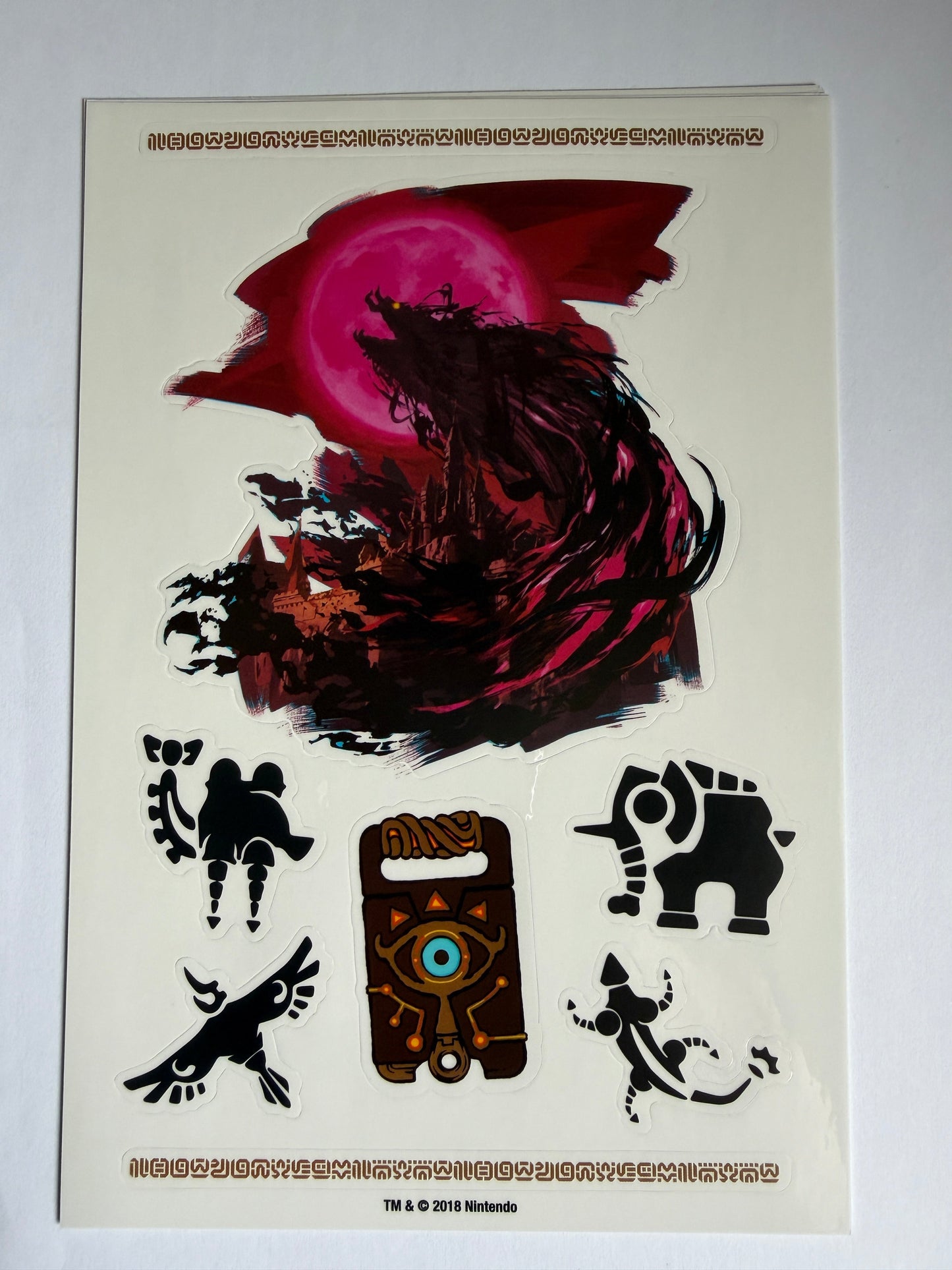 Sheet of stickers with various designs on a beige background